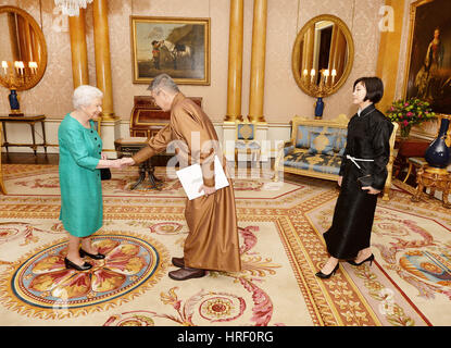 Queen Elizabeth II with Mr Sanjaa Bayar the Ambassador of Mongolia, before he presents his Letters of Credence and who was accompanied by Mrs Erdenebileg Suvd, during a private audience with Her Majesty at Buckingham Palace in Westminster central London. Stock Photo