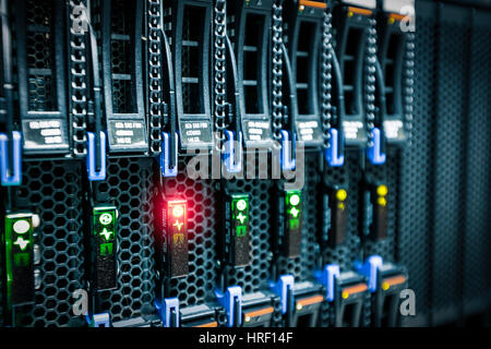 Computer Server mount on rack in data center room with red lighting alarm. Stock Photo