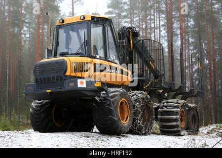 SALO, FINLAND - DECEMBER 18, 2016: PONSSE Elk forest forwarder in foggy pine forest in winter. The Elk has the load carrying capacity of 13 000 kg. Stock Photo