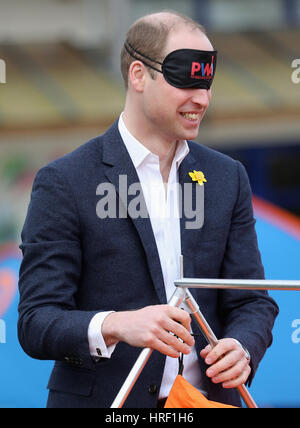 A blindfolded Duke of Cambridge playing with schoolchilren at Llanfoist Fawr Primary School in Abergavenny, Wales, where he officially launched the SkillForce Prince William Award encouraging children to develop good character, confidence and resilience. Stock Photo