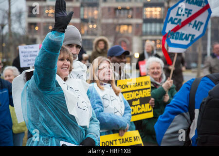 Birmingham, Michigan - With some wearing hospital gowns, people rally to save affordable health care. They were protesting Republicans' plan to repeal Stock Photo