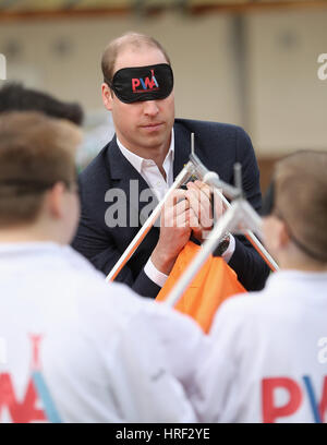 A blindfolded Duke of Cambridge playing with schoolchilren at Llanfoist Fawr Primary School in Abergavenny, Wales, where he officially launched the SkillForce Prince William Award encouraging children to develop good character, confidence and resilience. Stock Photo