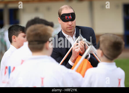 A blindfolded Duke of Cambridge playing with schoolchilren at Llanfoist Fawr Primary School in Abergavenny, Wales, where he officially launched the SkillForce Prince William Award encouraging children to develop good character, confidence and resilience. Stock Photo