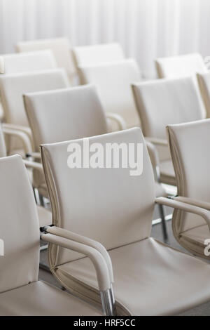 background of row of white seats. Empty hairs in the conference hall Stock Photo