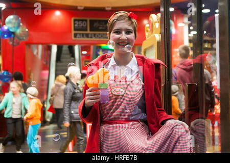 London, UK. 28 November 2015. A girl dressed as a festive gdall helps to entertain hundreds of people gathered in Regent Street, which has been closed Stock Photo