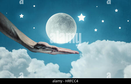 Human hand holding moon planet in palm Stock Photo