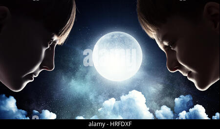 Profile image of cute girl and boy against night sky background Stock Photo