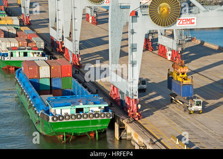 Aerial view of the Cai Mep International Terminal in Vietnam with containers being unloaded by an (sts) ship-to-shore crane or container handling gant Stock Photo
