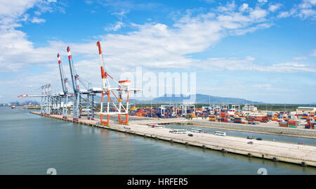 A 2 picture stitch panoramic aerial view of the Cai Mep International Terminal in Vietnam with container handling gantry cranes on a sunny day. Stock Photo