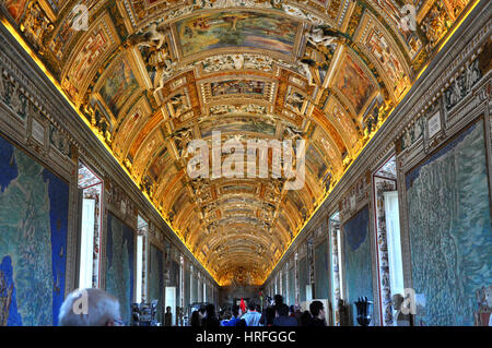 VATICAN, ITALY - MARCH 14, 2016: Tourists visiting the famous Gallery of Maps in the Vatican Museum, one of the major tourist attraction of the Vatica Stock Photo