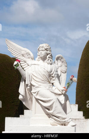 Angel statue holding flowers in Punta Arenas municipal cemetery, Patagonia, Chile Stock Photo
