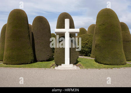 Christian cross and topiary cypress trees in Punta Arenas municipal cemetery Stock Photo