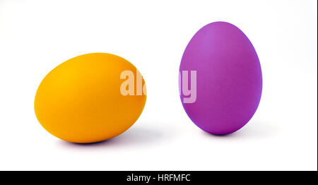 A Yellow and a purple dyed  Easter eggs on white. Stock Photo