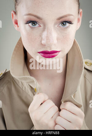 Young woman wearing trench coat Stock Photo