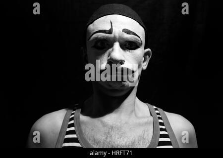 Funny portrait of theatrical mime on a black background Stock Photo