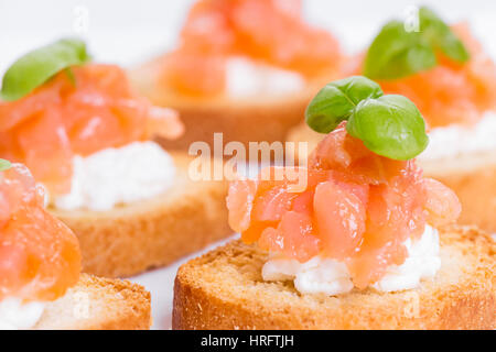 Canapes with smoked salmon, cream cheese and basil Stock Photo