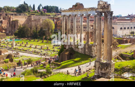 Rome, Italy.  The Roman Forum. The three columns in the foreground are those of the Temple of Vespasian. Behind are the columns of the Temple of Satur Stock Photo