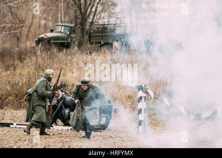 Gomel, Belarus - November 26, 2016: Re-enactors Dressed As German Wehrmacht Soldiers In Ww Ii Are Running On Battlefield. Celebration Of 73rd Annivers Stock Photo