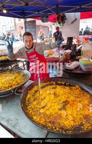 Street food - Portobello Road Market, food stall, Portobello Road, Notting Hill, London UK, making Paella Stock Photo
