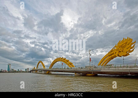 A wide angle HDR image view of the Dragon Bridge across the River Han in Da Nang, Vietnam with a cloudy dramatic sky. Stock Photo