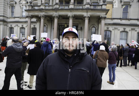Trenton, New Jersey, USA. 27th Feb, 2017. NICK RUGGIA, 30, of a media freelancer of Jersey City, New Jersey expressed his concern for the Affordable Cares Act that may be repealed during a rally at the Statehouse in Trenton, New Jersey. Ruggia suffers from obsessive compulsive disorder, also known as, OCD. 'For the last four years'' he has been 'ACA related health programs.'' 'Having access through medication has allowed me to lead a productive, interesting and fun life.'' 'If you take away our access to health care you are literally threatening our basic existence'' said Ru Stock Photo