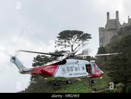 St Michaels Mount, Cornwall, UK. 1st March 2017. Newquay based coastguard Helicopter on approach to land at St Michaels Mount, Cornwall,UK Credit: Bob Sharples/Alamy Live News Stock Photo