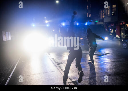 Denmark, Copenhagen, March 1st. 2017. Left wing activists took the streets of Copenhagen ten years after the demolition of the Ungdomshuset youth house at Jagtvej 69. Under the statement “The fight continues, nothing forgotten, nothing forgiven” the activists clashed with the police during the march. Here the activists attack the police with stones. Credit: Gonzales Photo/Alamy Live News Stock Photo