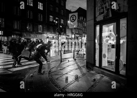 Denmark, Copenhagen, March 1st. 2017. Left wing activists took the streets of Copenhagen ten years after the demolition of the Ungdomshuset youth house at Jagtvej 69. Under the statement “The fight continues, nothing forgotten, nothing forgiven” the activists clashed with the police during the march. Here the activists attack a bank with stones. Credit: Gonzales Photo/Alamy Live News Stock Photo