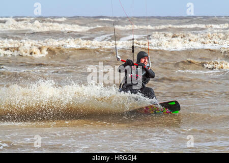 Ainsdale, Merseyside. 2nd March 2017. UK Weather.  Kite surfers take to the waves as high tide strikes the north west coastline at Ainsdale on Merseyside.  Blue skies, bright sunshine & a whipped up waves made for near perfect surfing conditions.  Credit: Cernan Elias/Alamy Live News Stock Photo