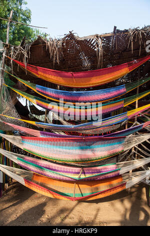 Hammock,hammocks,for,sale,at,market,stall.Tourists,tourism,at,on,famous,famed,Wednesday,Anjuna,Flea,Market,Beach,Goa,India,Indian,Asia,Asian, Stock Photo