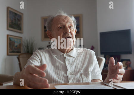 Former General Secretary of the Communist Party of Czechoslovakia Milos Jakes at age 94 gestures during an interview at his apartment in Prague, Czech Republic, on November 22, 2016. Stock Photo