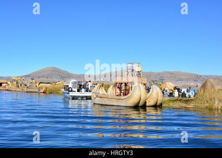 Typical peruvian boat (aka Totora boat) in the island of Uros, Titicaca lake, Peru. The tours to this island departure from the city of Puno. Stock Photo