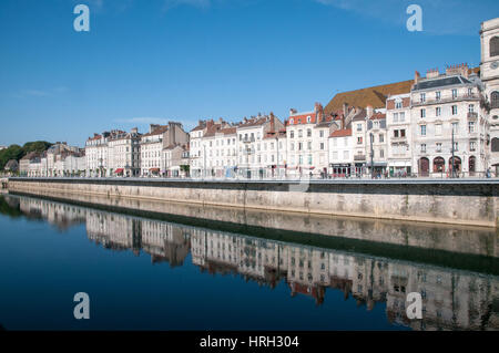 Buildings along Quai Veil Picard in Besancon with the river Les Doubs in the foreground and refelctions and blue sky Stock Photo