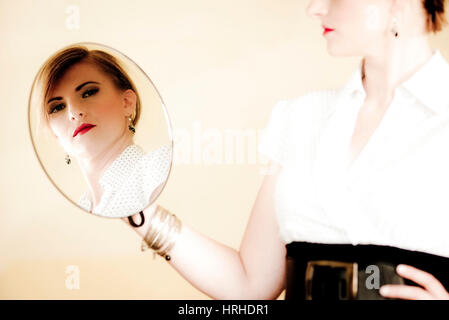 Spiegelbild einer jungen, attraktiven Frau - young, attractive woman in a mirror Stock Photo