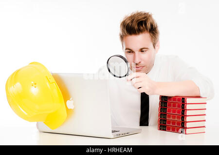 Geschaeftsmann mit Laptop, Lupe und Buchstapel - business man Stock Photo