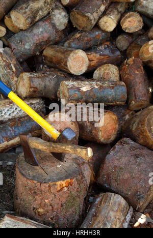 wood pile with axes and chopping block Stock Photo