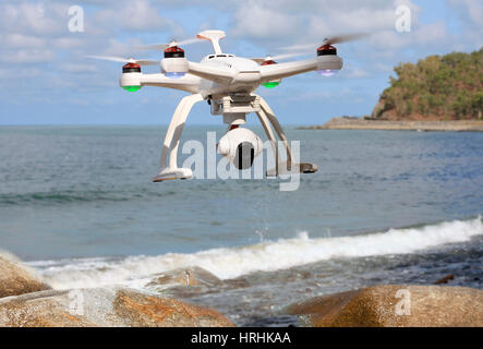 drone with camera flying over the sea Stock Photo