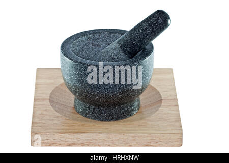 Mortar and pestle on a wooden chopping board isolated on a white background Stock Photo