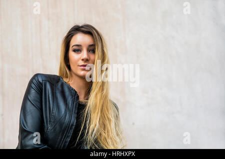 Young woman in black leather jacket outdoor Stock Photo