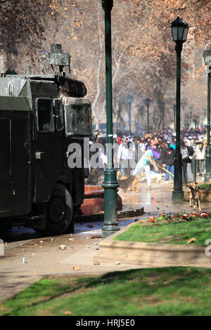 Chilean police water cannon disperse protesters during a student strike in Santiago's Downtown, Chile. Protesters Stock Photo