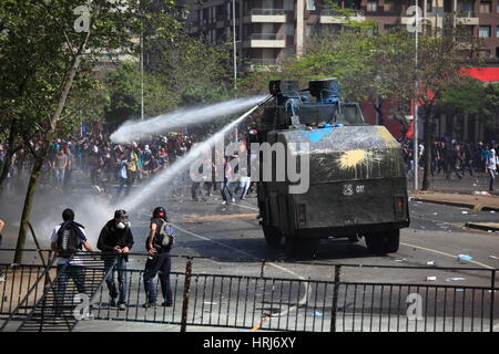 Chilean police water cannon disperse protesters,during a student strike in Santiago's Downtown, Chile. Stock Photo