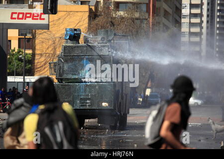 Chilean police water cannon disperse protesters,during a student strike in Santiago's Downtown, Chile. Stock Photo