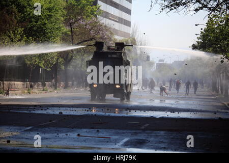 Chilean police water cannon disperse protesters,during a student strike in Santiago's Downtown, Chile. Stock Photo