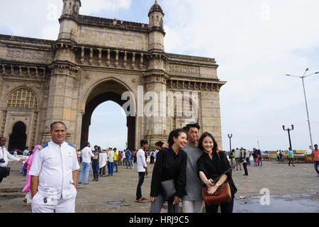 Tourist are taking selfies at Gateway of India in Mumbai. There faces expressions attracted to take pics of them Stock Photo