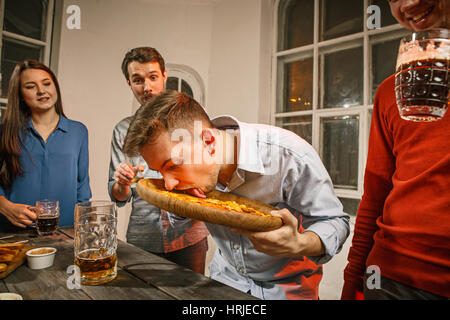 Group of friends enjoying evening drinks with beer Stock Photo