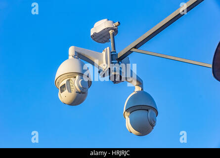 Security cctv cameras on pylon in blue background Stock Photo