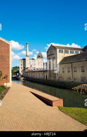 Stroud, Gloucestershire, UK - 26th August 2016: Summer sunshine brings people out to enjoy the regenerated Stroudwater Canal project at Ebley, Stroud, Gloucestershire, UK.  Recently built apartment buildings and businesses in old industrial premises enhance the canalside around historic Ebley Mill. Stock Photo