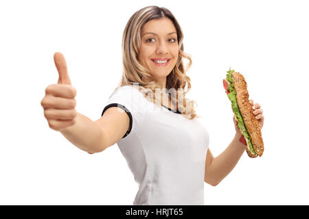Happy woman with a sandwich making a thumb up gesture isolated on white background Stock Photo