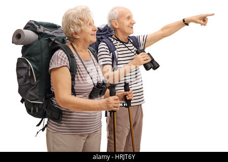 Male and a female mature hiker with one of them pointing in the distance isolated on white background Stock Photo