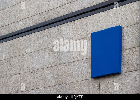 Horizontal side view of empty square blue signage on business building covered in marble Stock Photo